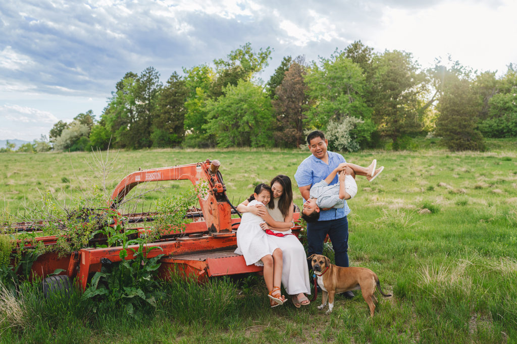 Denver Family Photographer captures family playing outdoors with dog during family photos