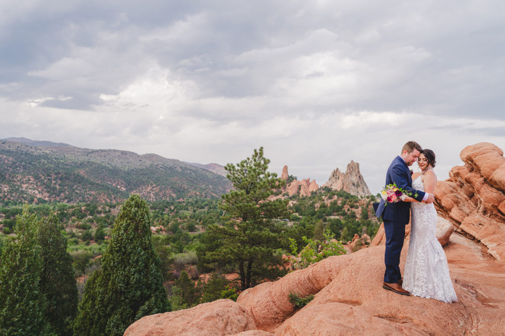 Colorado elopement photographer captures couple hugging on red rock after Colorado elopement