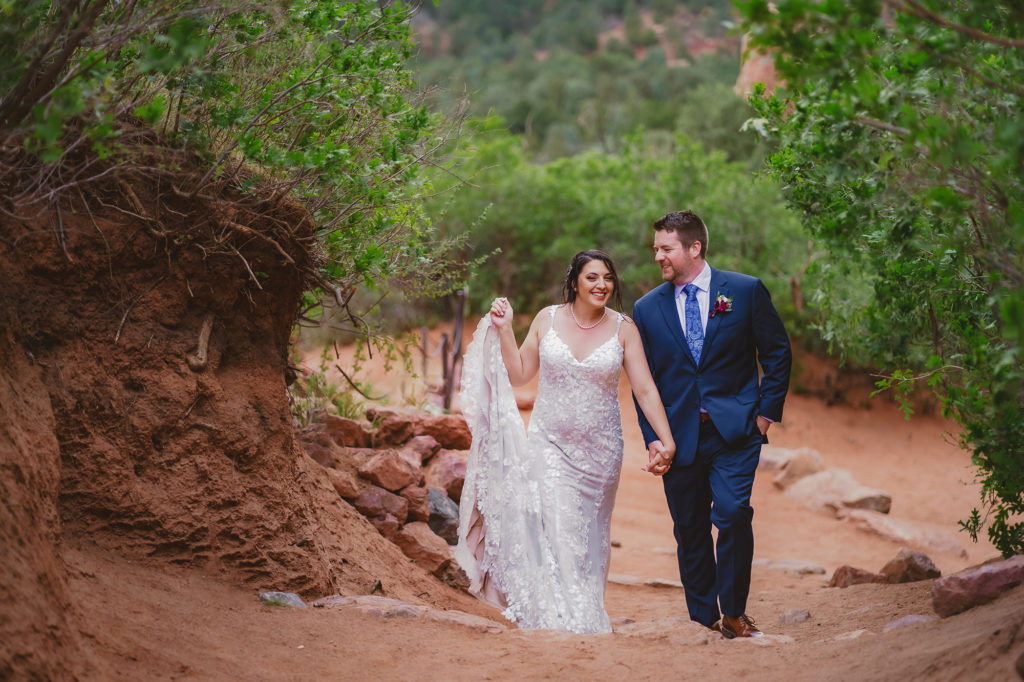 Colorado elopement photographer captures bride and groom holding hands and walking
