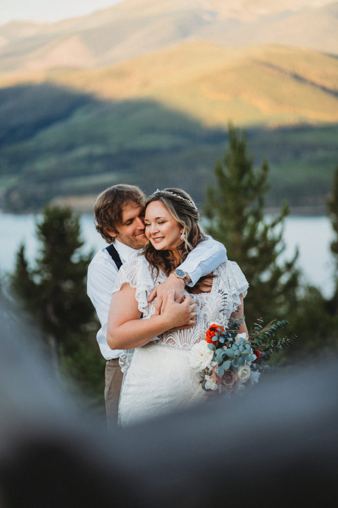 Colorado elopement photographer captures groom hugging bride from behind during bridals