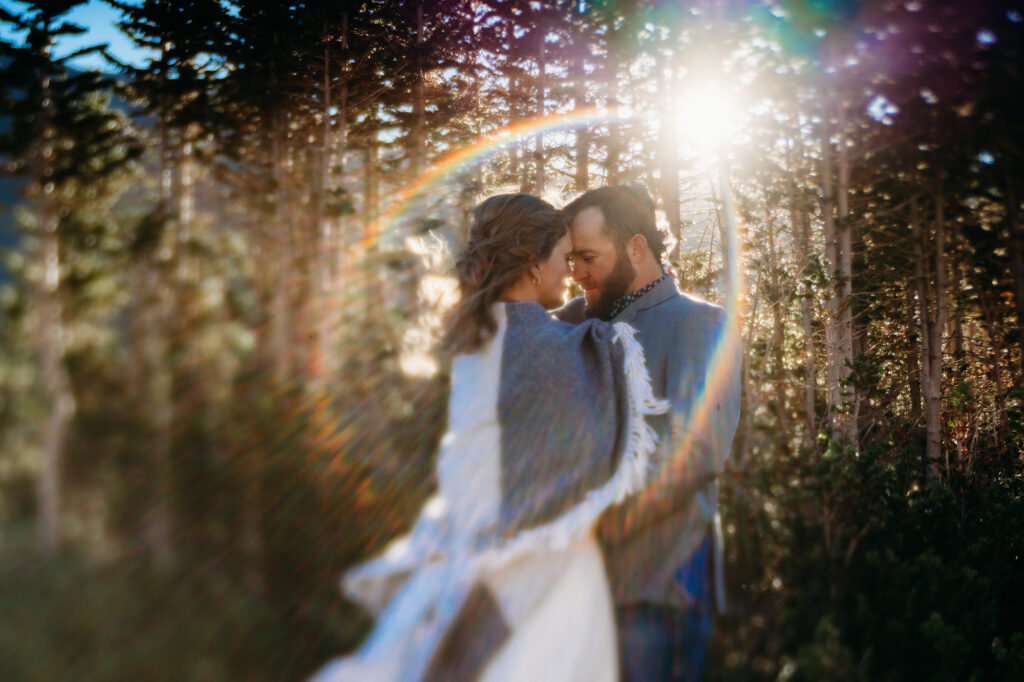 Colorado elopement photographer captures bride and groom under blanket during golden hour portraits