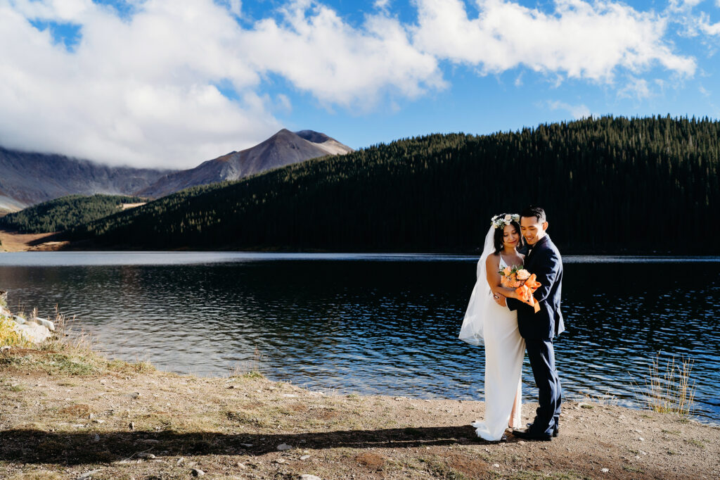 Colorado elopement photographer captures bride and groom embracing lakeside