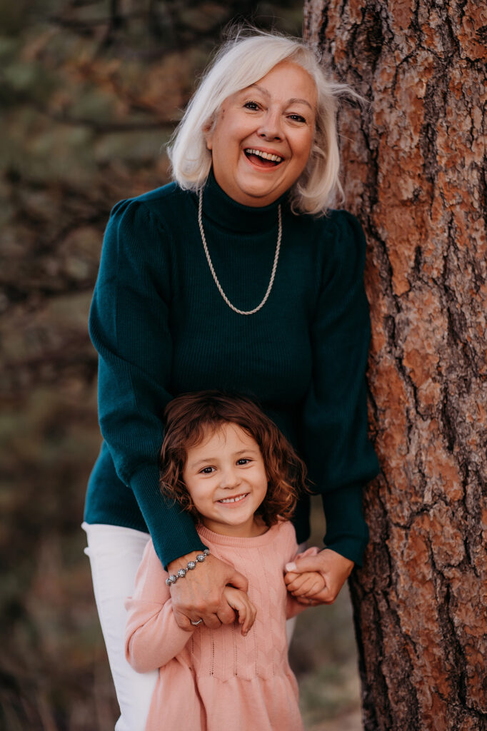 Grandmother wearing blue sweater holding grandchild