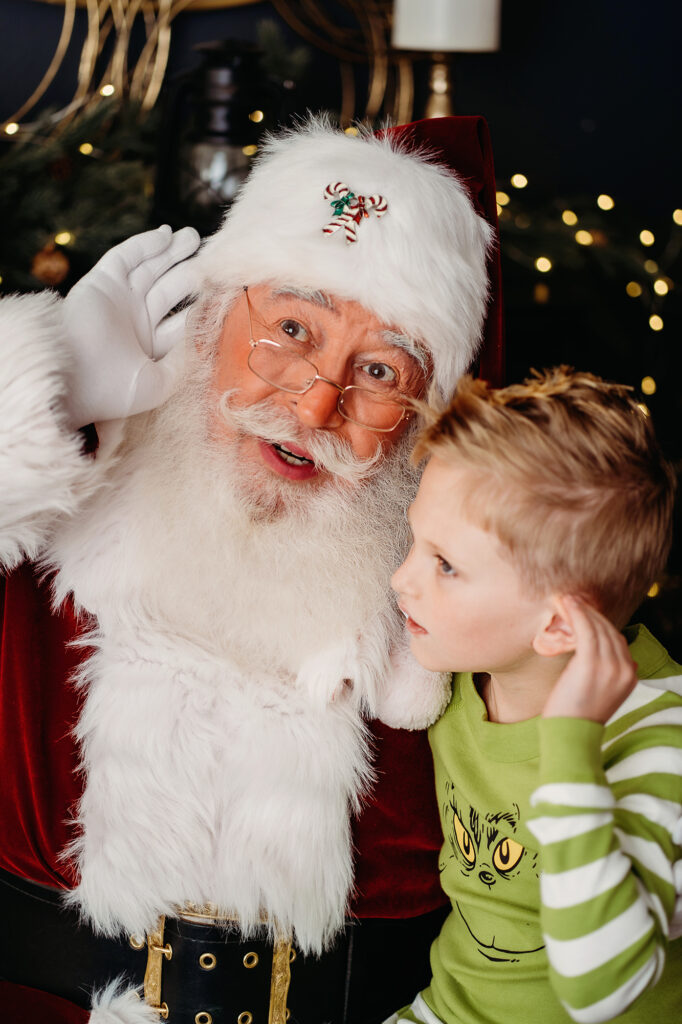 Denver Family Photographer captures boy sitting with Santa and listening to magic