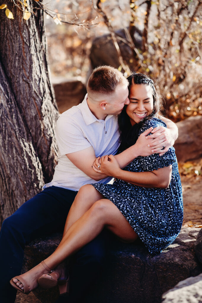 Colorado elopement photographer captures couple hugging and kissing during engagement photos