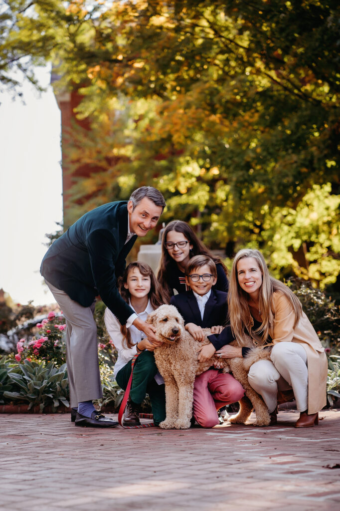 Denver Family Photographer captures family standing with dog during outdoor family photos