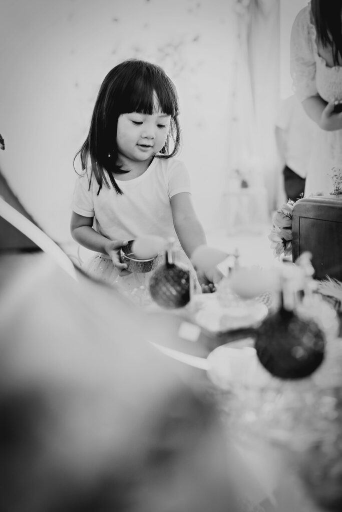 little girl playing at a vanity during a mothers day photo shoot with denver family photographer 
