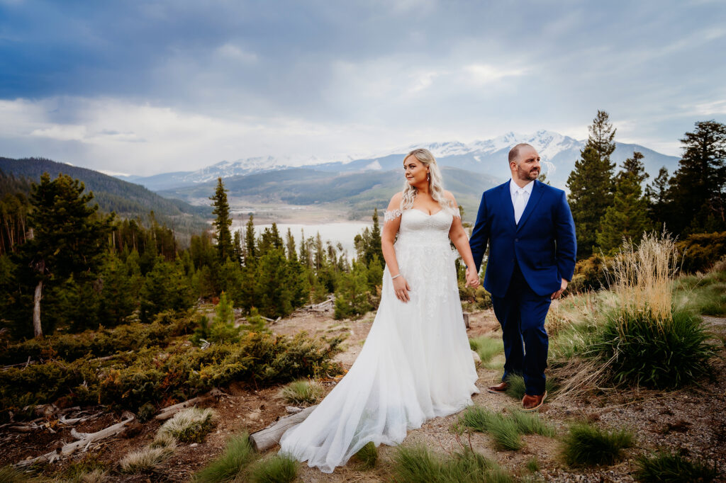 Colorado elopement photographer captures bride and groom after elopement holding hands in wedding attire