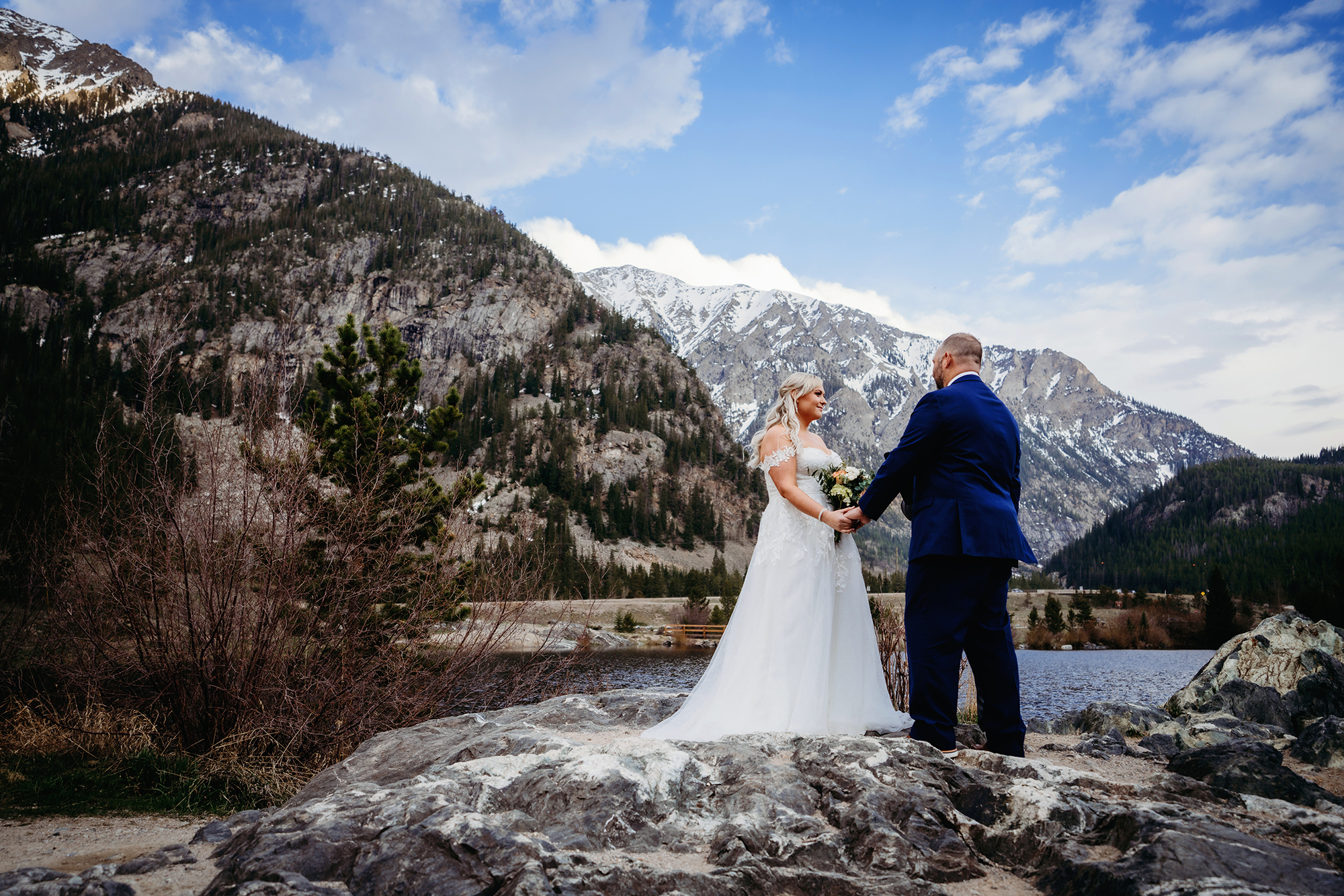 Colorado elopement photographer captures bride and groom holding hands during elopement ceremony