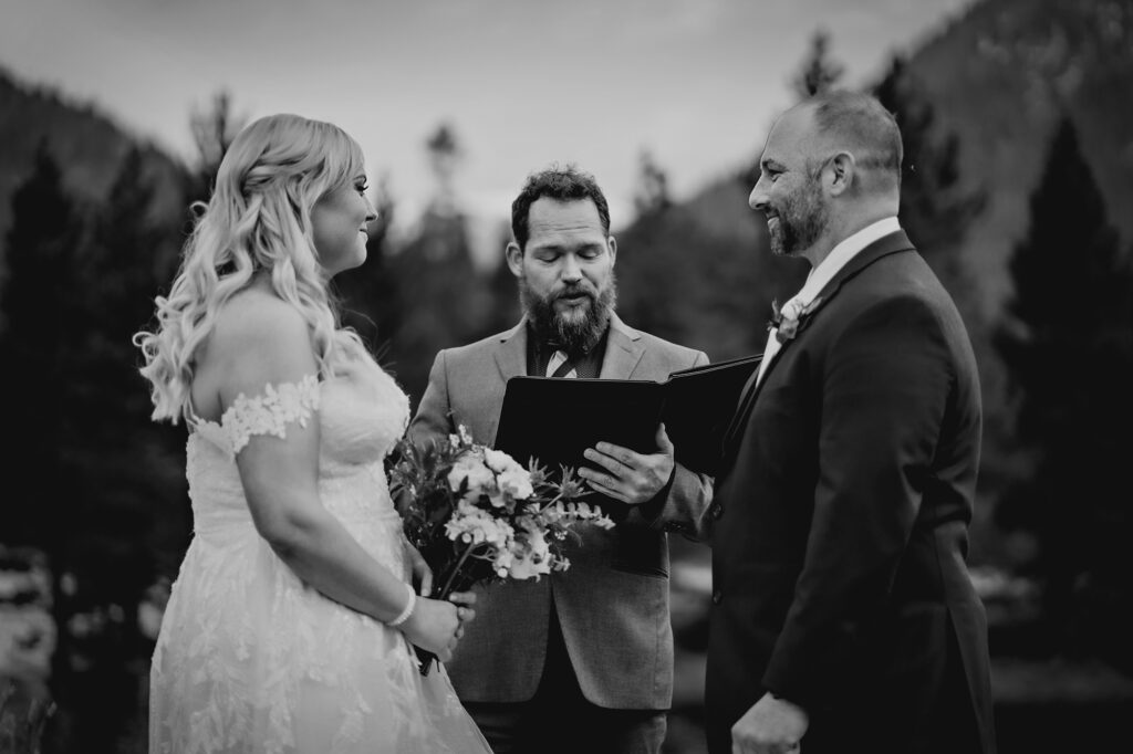 Colorado elopement photographer captures bride and groom looking at one another during elopement ceremony