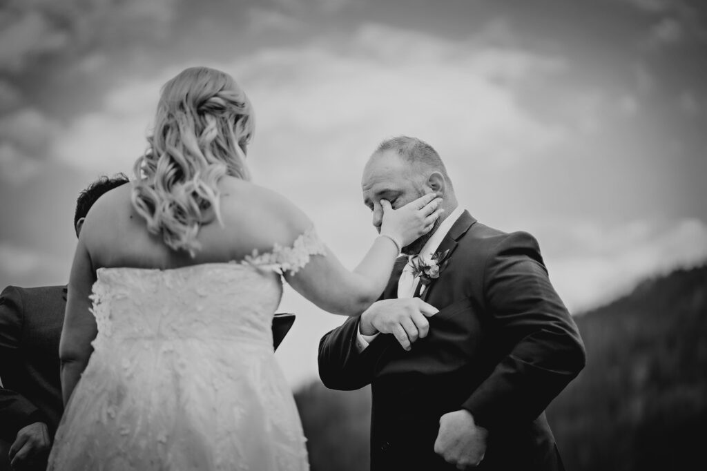 Colorado elopement photographer captures bride wiping groom’s tears during intimate Denver elopement ceremony