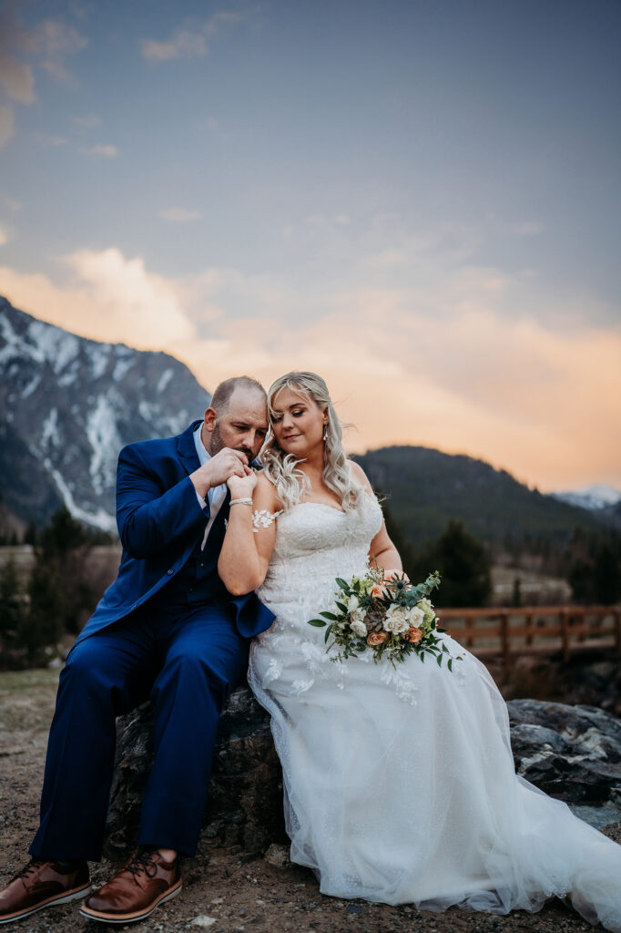 Colorado elopement photographer captures newly married bride and groom sitting together during bridal portraits