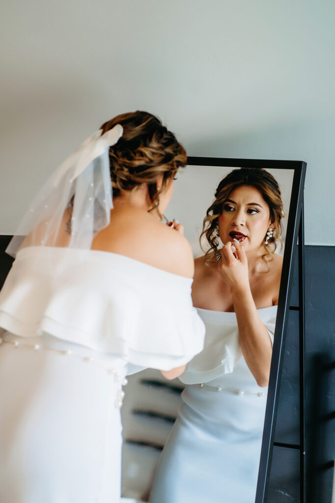 Colorado elopement photographer captures bride touching up makeup before Colorado elopement ceremony