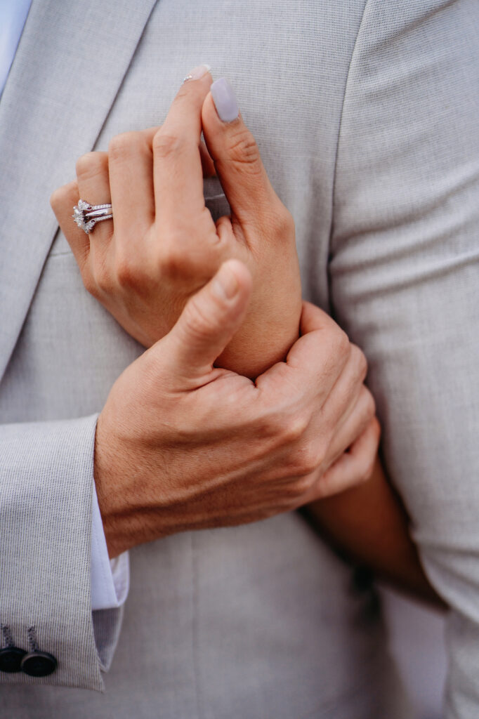 Colorado elopement photographer captures close up of bride and grooms hands