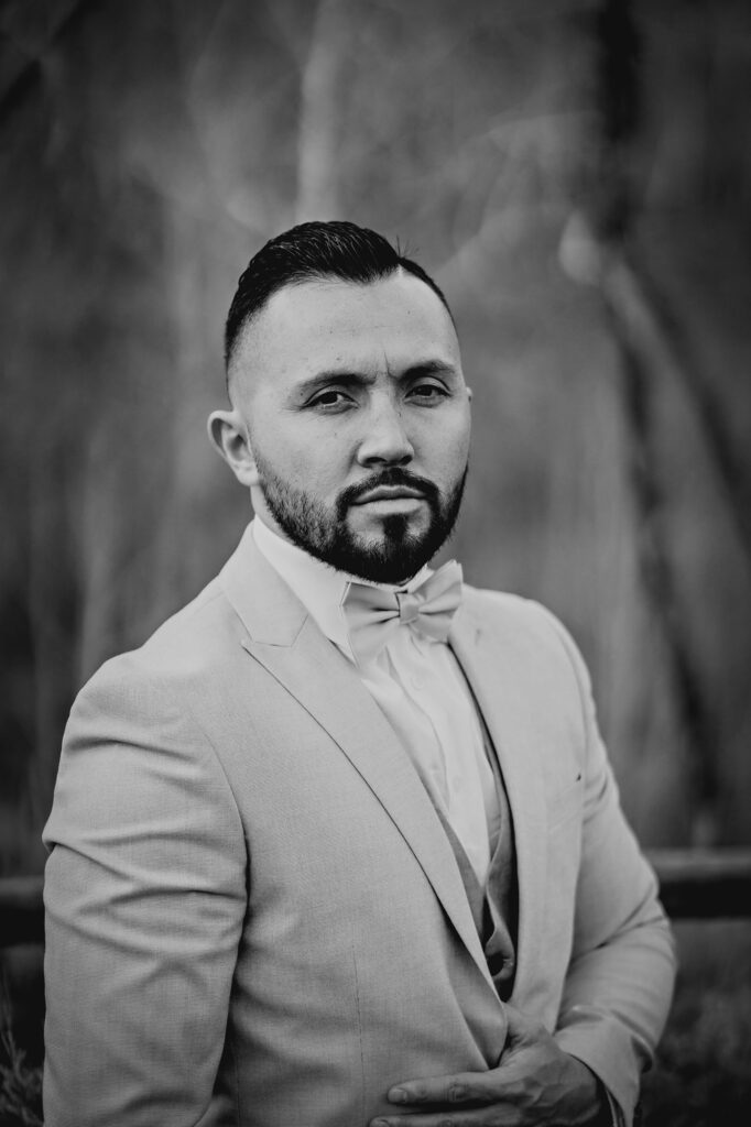 Colorado elopement photographer captures black and white portrait of groom after intimate outdoor ceremony