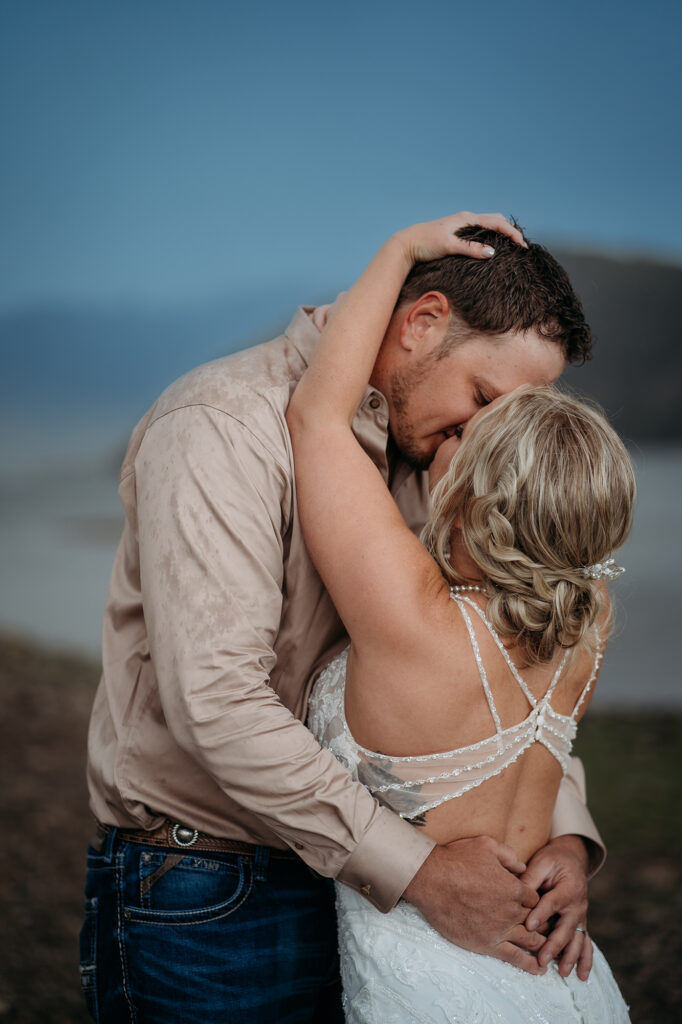 Denver wedding photographer captures bride holding man's face while kissing