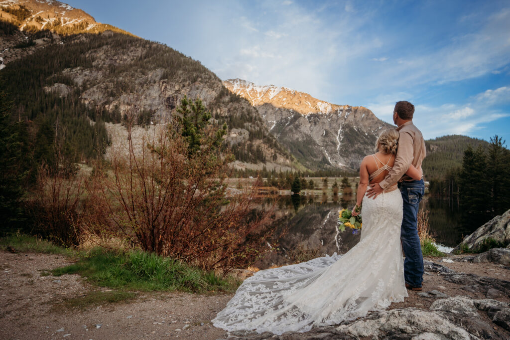 Denver wedding photographer captures bride and groom looking at sunset 