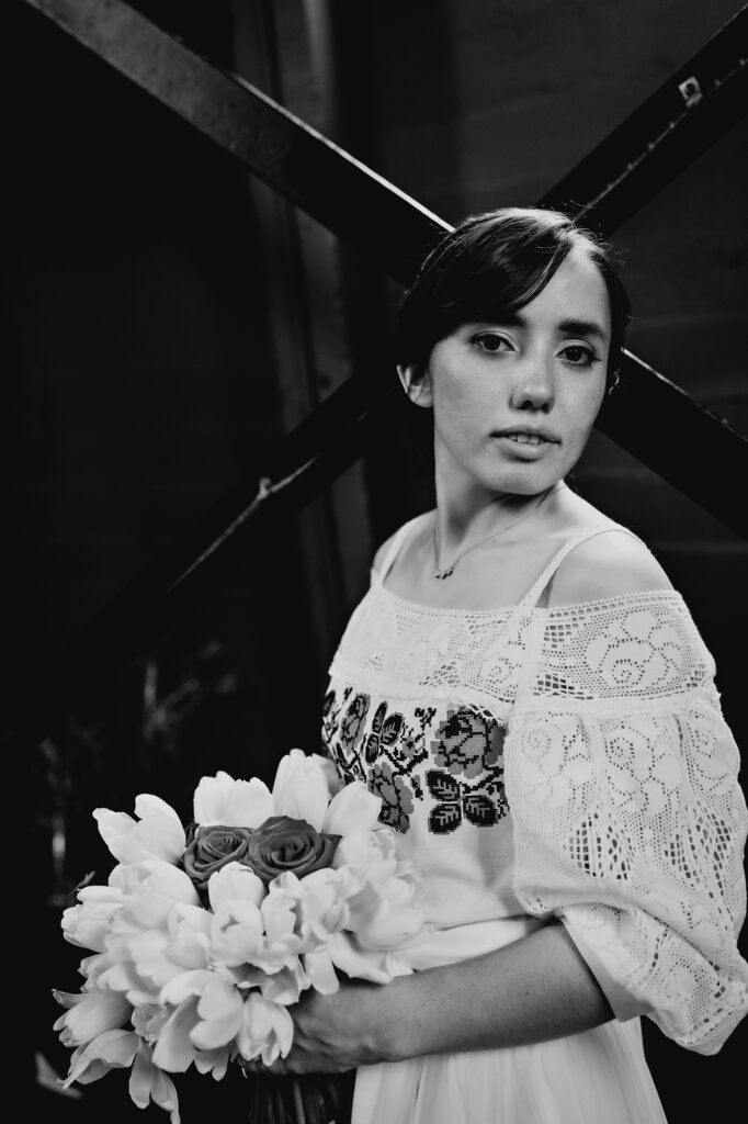 Colorado elopement photographer captures black and white portrait of bride holding bridal bouquet while wearing wedding dress