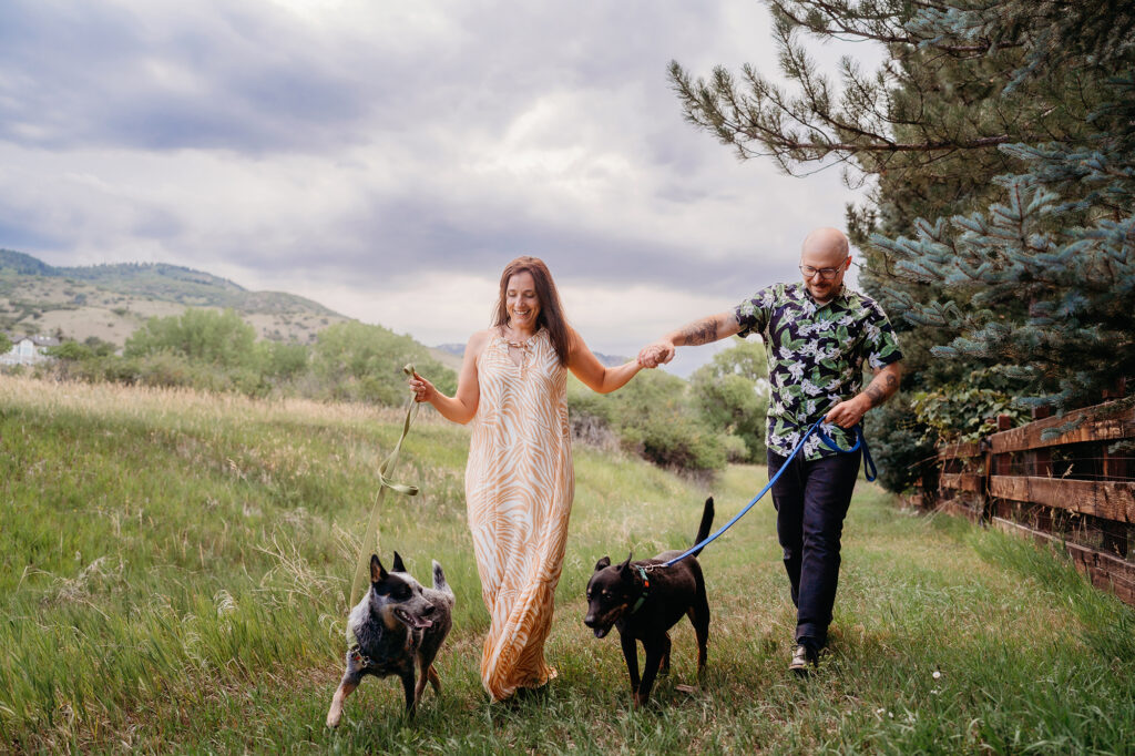 Denver wedding photographer captures woman wearing pink dress walking dog