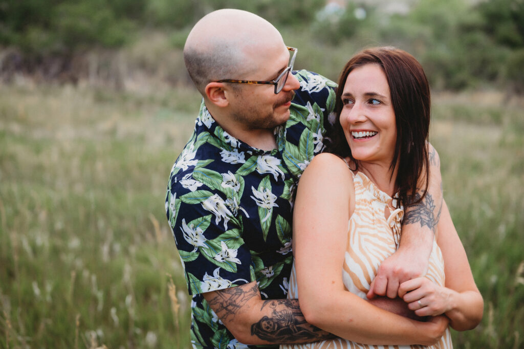 Denver wedding photographer captures man hugging woman during destination Colorado engagements
