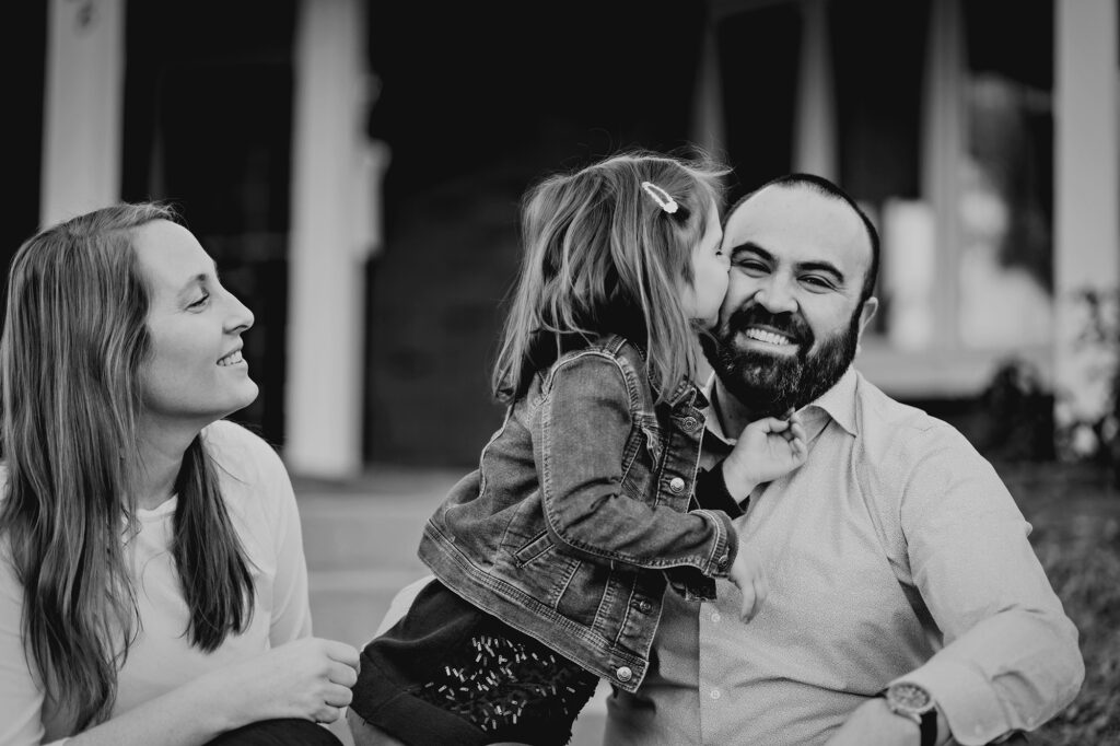 Denver family photographers capture daughter kissing father on cheek