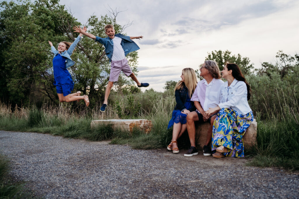 Denver family photographers capture children jumping in air during family photos