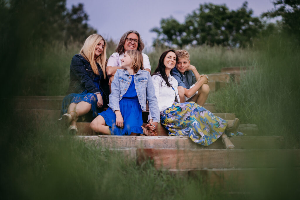 Denver family photographers capture family wearing blue sitting on blanket