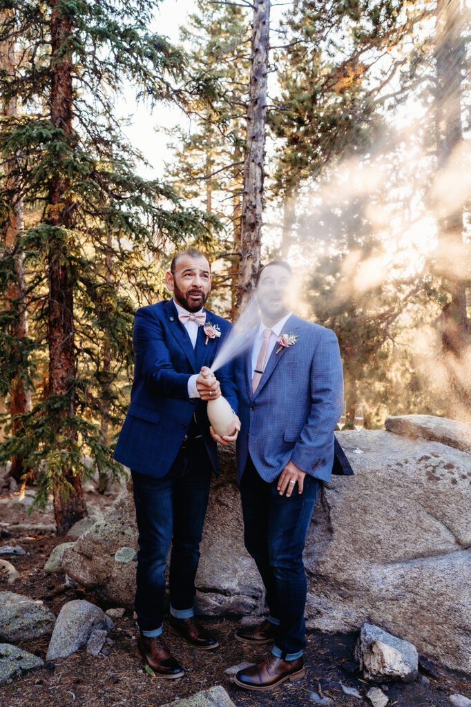 Colorado elopement photographer captures groom popping champagne after colorado elopement