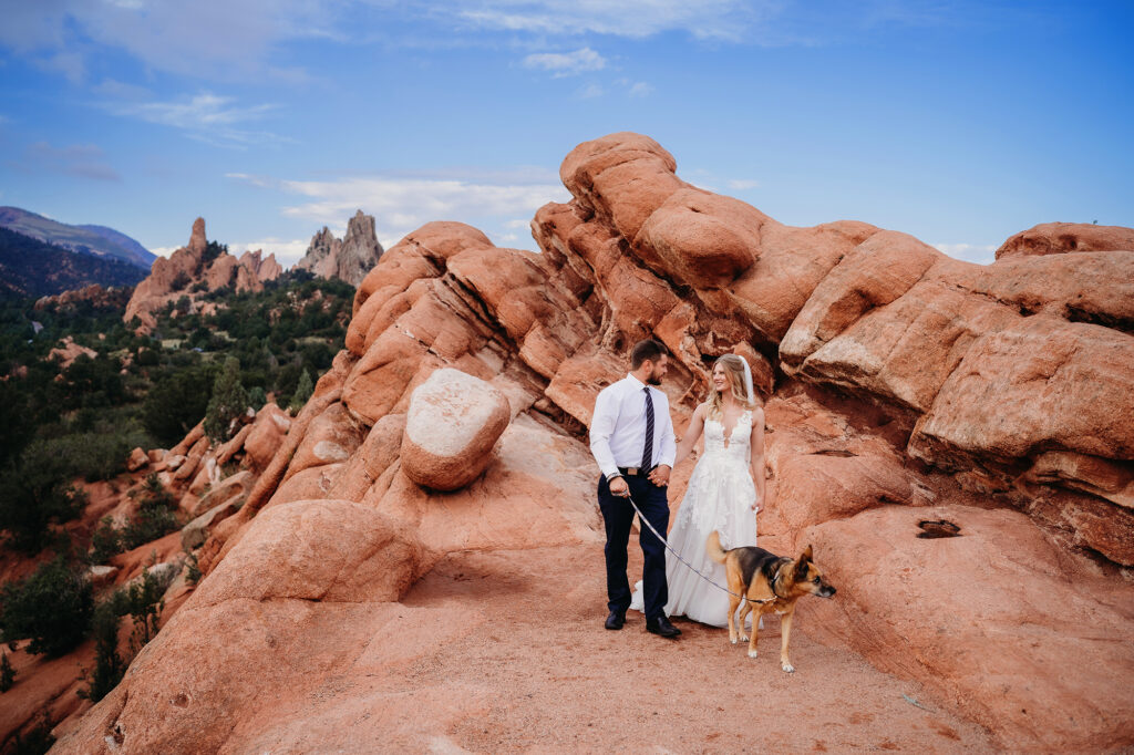 Colorado elopement photographer captures bride and groom walking on red rock