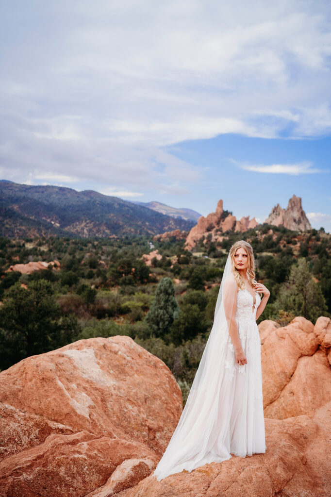 Colorado elopement photographer captures bride standing on red rock 