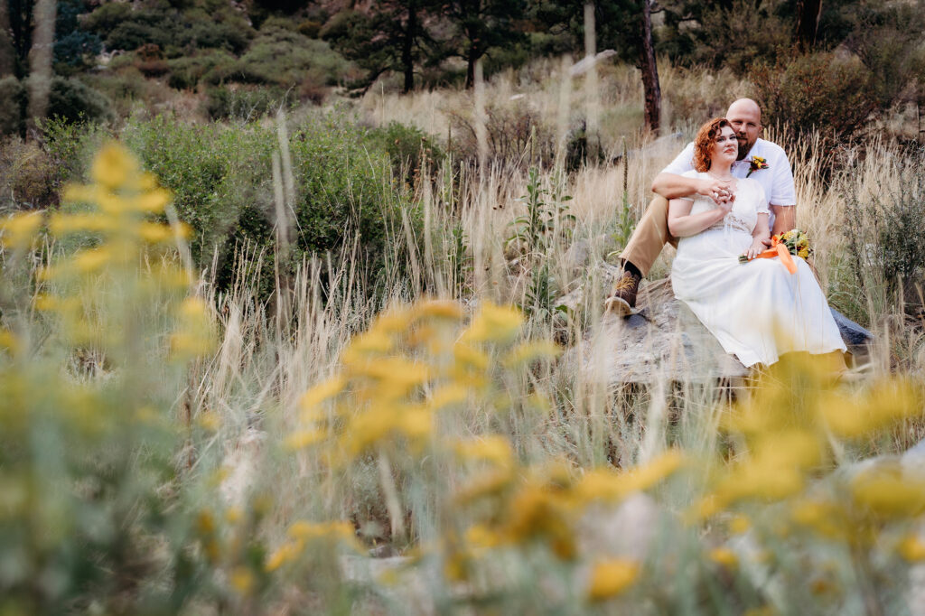 Colorado elopement photographer captures couple sitting together during bridal portraits