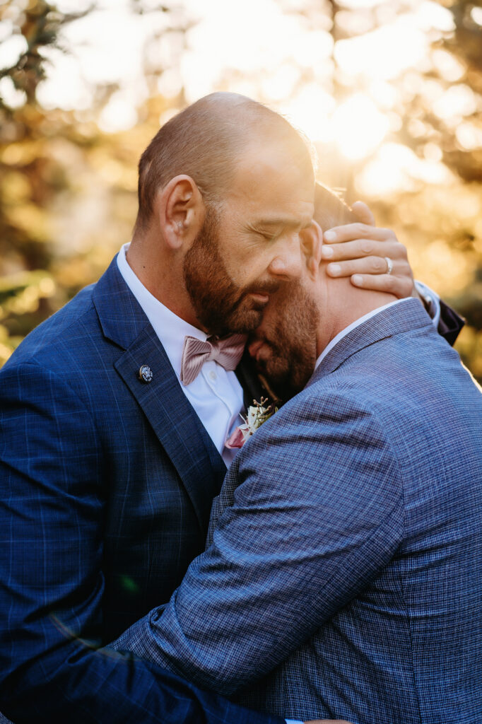 Colorado elopement photographers capture newly married husbands hugging