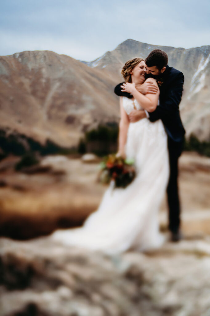 Colorado elopement photographer captures bride and groom embracing during portraits