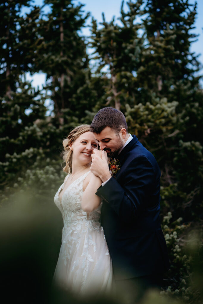 Colorado elopement photographer captures groom kissing bride's hand