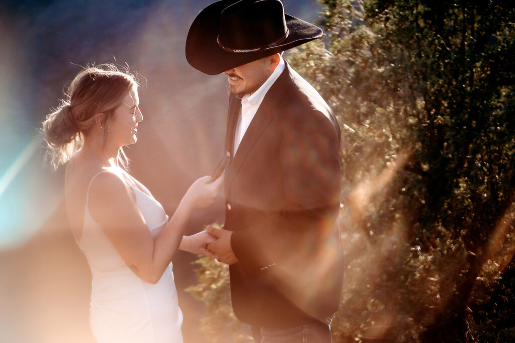 Colorado elopement photographers capture groom holding bride's hand during vows
