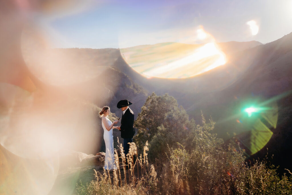 Colorado elopement photographers capture bride and groom on top of mountain during bridal portraits
