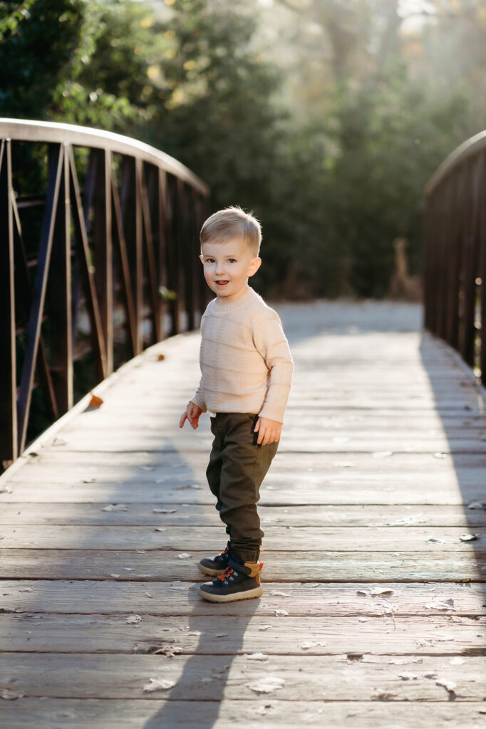 Denver family photographers capture boy playing on bridge