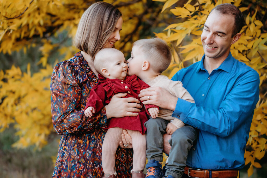 Denver family photographers capture kids kissing during family portraits