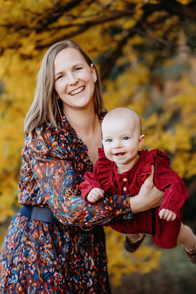 Denver family photographers capture mother holding baby smiling 