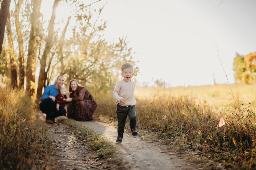 Denver family photographers capture son running while family watches