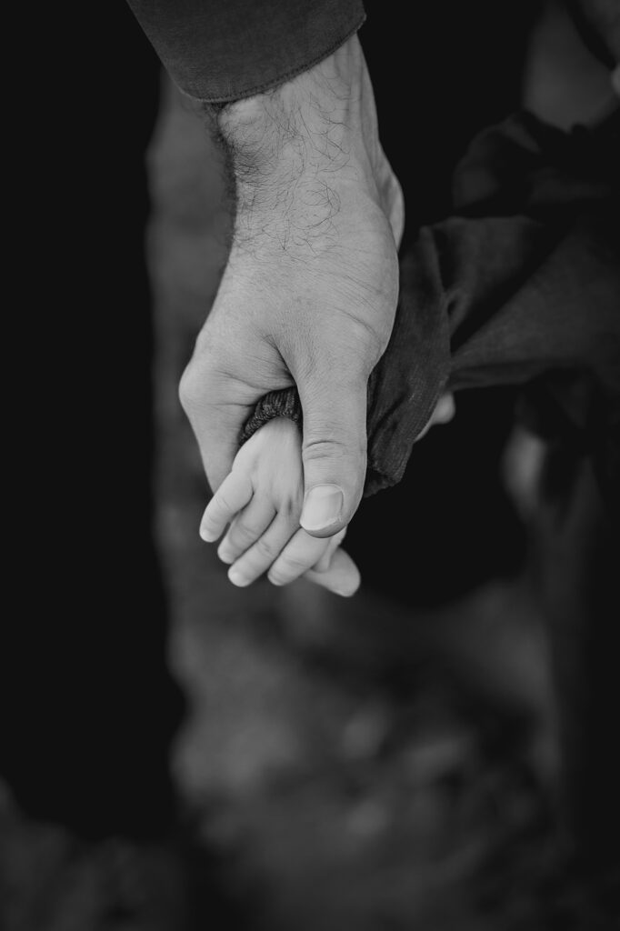 Denver Family Photographers capture father holding baby's hand 