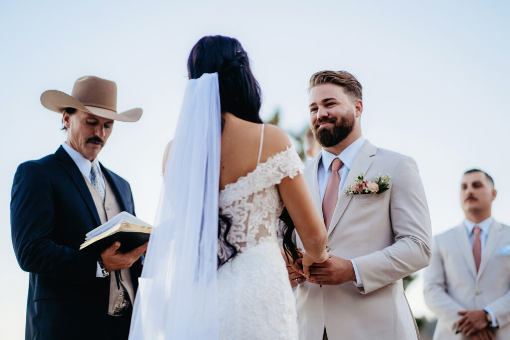 Colorado elopement photographer captures bride and groom holding hands during ceremony