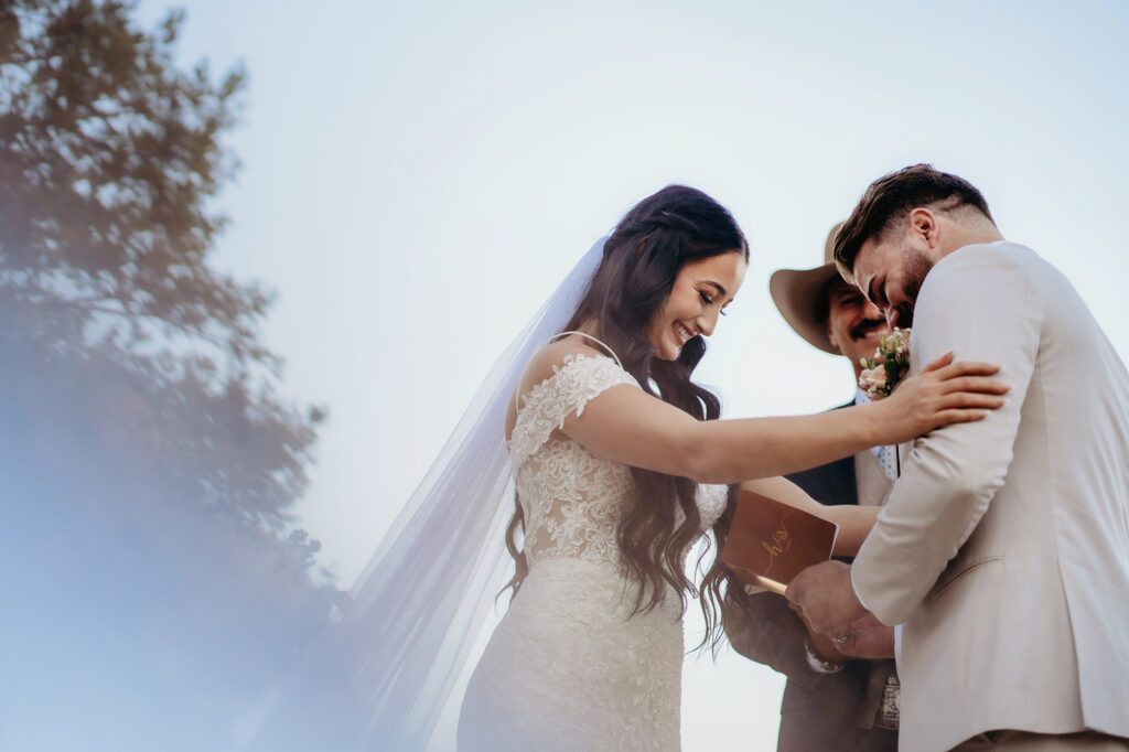 Colorado elopement photographer captures bride holding groom's shoulders