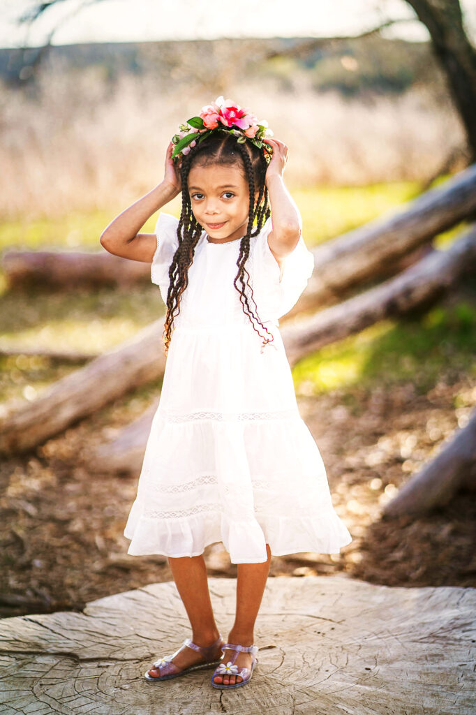 Denver family photographers capture girl wearing white dress and floral crown