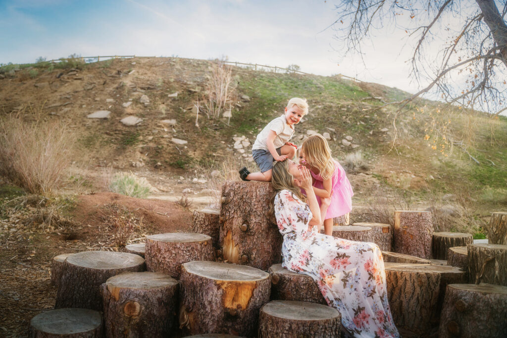 Denver family photographer captures mother hugging children during morning photo session
