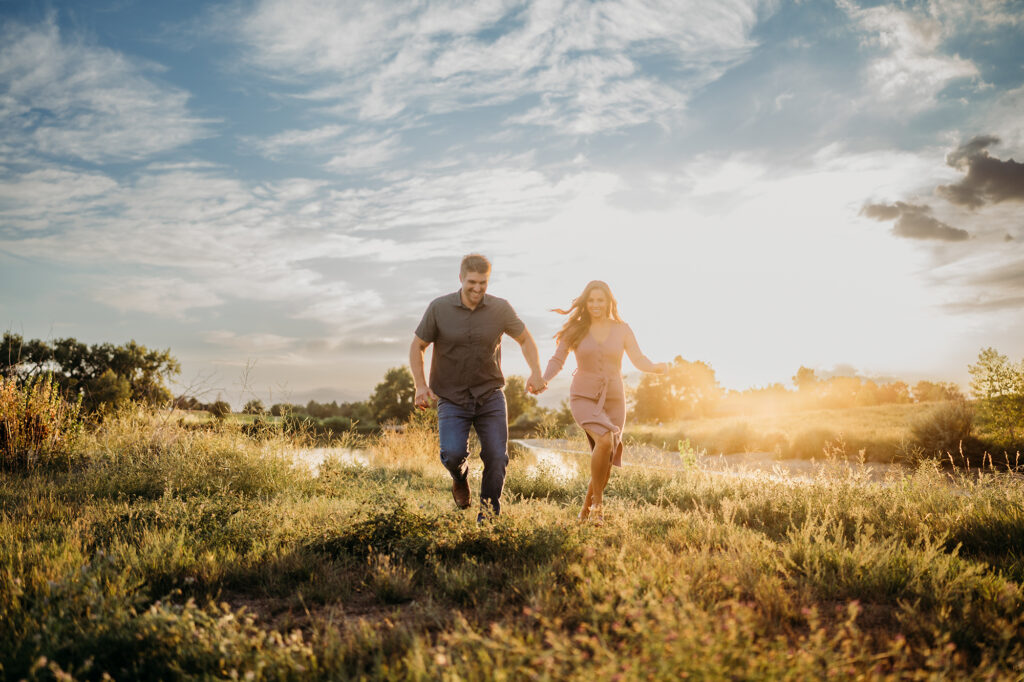 Colorado elopement photographer captures couple running through field in golden hour