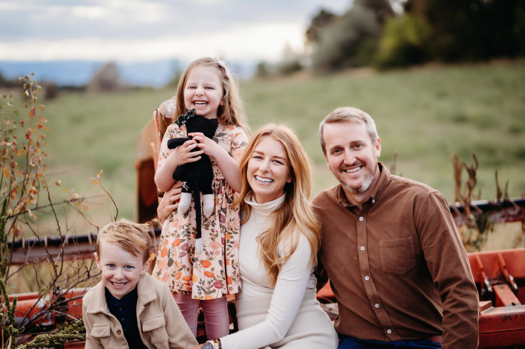Denver family photographers capture family smiling together during outdoor family photos