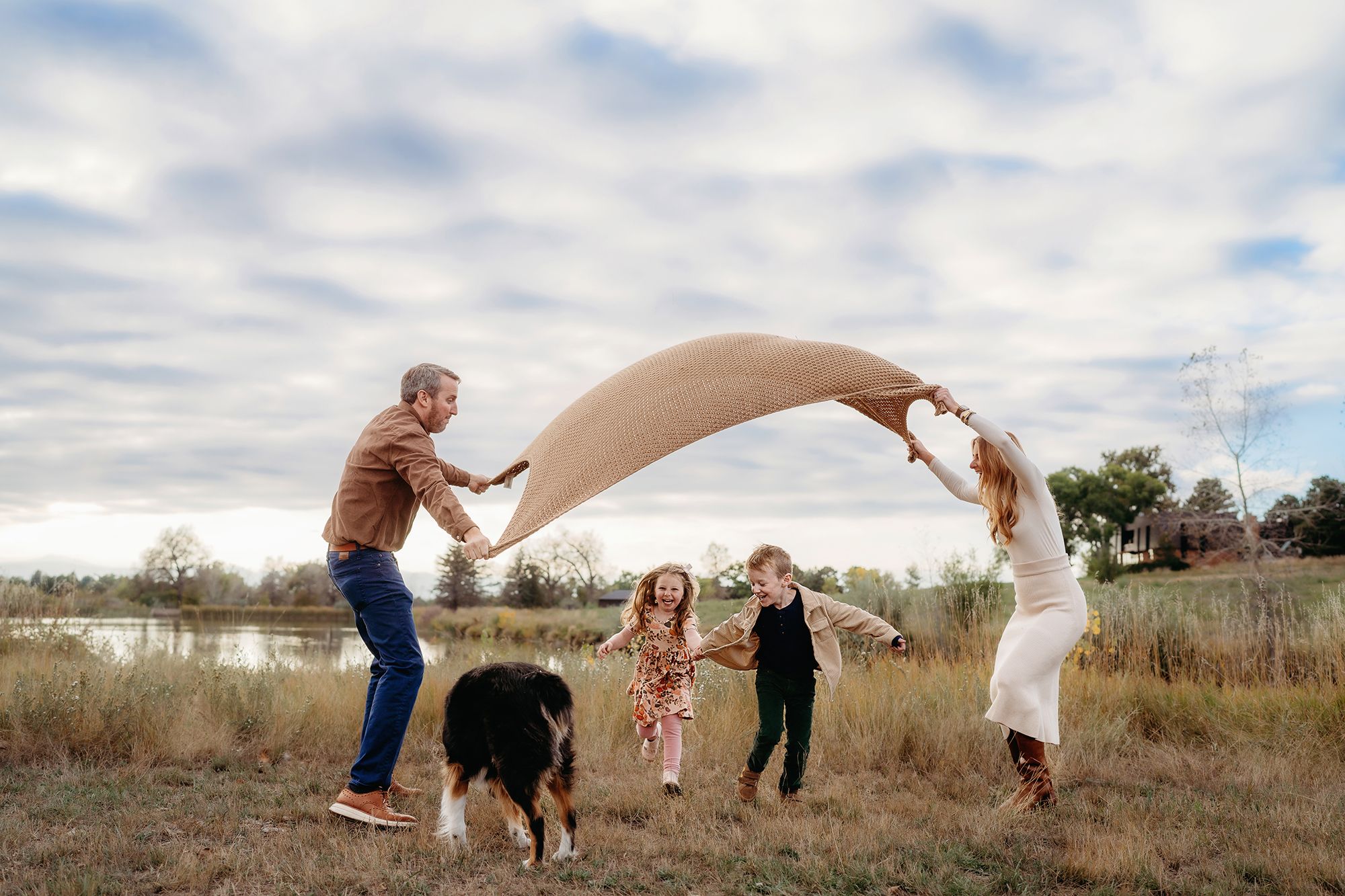 Denver family photographers capture family playing with parachute