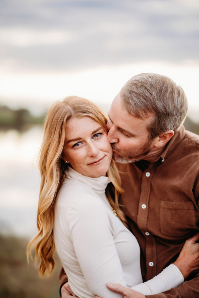 Denver family photographers capture man kissing woman's cheek