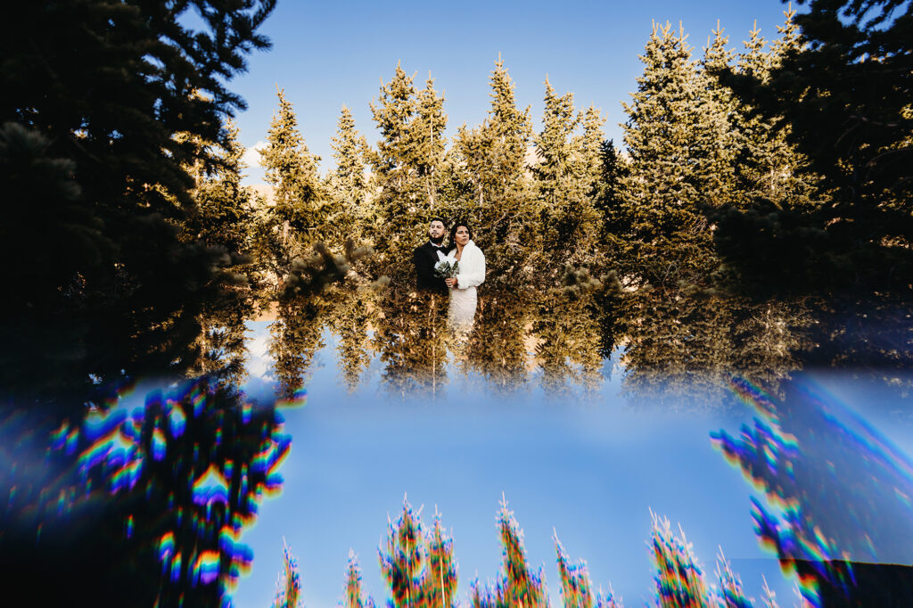 Colorado elopement photographer captures reflection of bride and groom in forest pictures